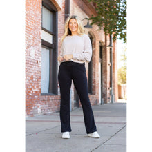 Load image into Gallery viewer, High-waisted black bootcut leggings by Julia Rose, Julia Rose women’s flared black leggings lifestyle image