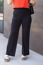 Load image into Gallery viewer, High-waisted black wide leg pants with pockets by Julia Rose, Julia Rose women’s wide leg pants lifestyle image