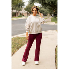 Load image into Gallery viewer, High-waisted maroon bootcut leggings with pockets by Julia Rose, Julia Rose women’s maroon flared leggings lifestyle image