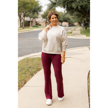 Load image into Gallery viewer, High-waisted maroon bootcut leggings with pockets by Julia Rose, Julia Rose women’s maroon flared leggings lifestyle image