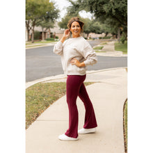 Load image into Gallery viewer, High-waisted maroon bootcut leggings with pockets by Julia Rose, Julia Rose women’s maroon flared leggings lifestyle image