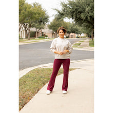 Load image into Gallery viewer, High-waisted maroon bootcut leggings with pockets by Julia Rose, Julia Rose women’s maroon flared leggings lifestyle image