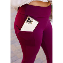 Load image into Gallery viewer, High-waisted maroon bootcut leggings with pockets by Julia Rose, Julia Rose women’s maroon flared leggings lifestyle image