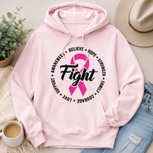 Load image into Gallery viewer, A light pink pullover hoodie with a pink awareness ribbon and the word 'Fight' printed on the chest, styled in a flat lay with a hat, jeans, a plant, a mug, and a blanket.