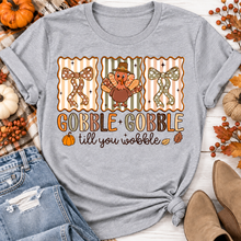 Load image into Gallery viewer, Gobble Gobble Till You Wobble Thanksgiving graphic apparel featuring a cute turkey, polka dot bows, retro fall colors, pumpkins and autumn leaves.