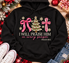 Load image into Gallery viewer, Christian Christmas shirt featuring I Will Praise Him in Every Season Psalm 146:2 graphic with pink bows, decorated Christmas tree, and cream snowflakes.