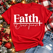 Load image into Gallery viewer, Faith Over Fear Christian inspirational graphic apparel featuring bold white Faith lettering, elegant Over Fear script, a small heart, and a cross design. Available in red and black in short sleeve crewneck, long sleeve crewneck, crewneck sweatshirt, and hoodie styles. Faith-based graphic clothing for women, everyday wear, church outfits, and inspirational gifts.