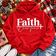 Load image into Gallery viewer, Faith Over Fear Christian inspirational graphic apparel featuring bold white Faith lettering, elegant Over Fear script, a small heart, and a cross design. Available in red and black in short sleeve crewneck, long sleeve crewneck, crewneck sweatshirt, and hoodie styles. Faith-based graphic clothing for women, everyday wear, church outfits, and inspirational gifts.