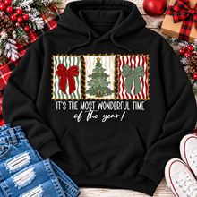 Load image into Gallery viewer, Black Christmas graphic hoodie featuring red and green holiday bows, decorated Christmas tree and It's the Most Wonderful Time of the Year lettering.
