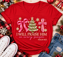 Load image into Gallery viewer, Christian Christmas shirt featuring I Will Praise Him in Every Season Psalm 146:2 graphic with pink bows, decorated Christmas tree, and cream snowflakes.