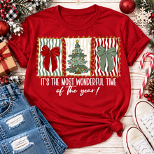 Load image into Gallery viewer, Red Christmas graphic tee featuring festive red and green bows, Christmas tree and holiday typography.