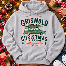 Load image into Gallery viewer, Christmas graphic tee featuring Griswold Christmas Tree Farm vintage green station wagon with Christmas tree and retro lettering.