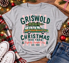 Load image into Gallery viewer, Christmas graphic tee featuring Griswold Christmas Tree Farm vintage green station wagon with Christmas tree and retro lettering.