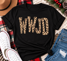 Load image into Gallery viewer, shirt with tan leopard-print WWJD lettering in a rustic holiday flat lay.