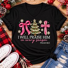 Load image into Gallery viewer, Christian Christmas shirt featuring I Will Praise Him in Every Season Psalm 146:2 graphic with pink bows, decorated Christmas tree, and cream snowflakes.