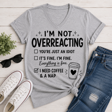 Load image into Gallery viewer, Gray I’m Not Overreacting graphic T-shirt featuring funny checklist sayings, black lettering, coffee cup graphic and I Need Coffee and a Nap text.