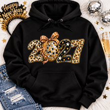 Load image into Gallery viewer, Black 2027 New Year's graphic apparel featuring leopard print numbers, a gold disco ball with an oversized glittery bow, black and gold stars, and sparkling accents. Available in crewneck tee, V-neck tee, sweatshirt, and hoodie styles.