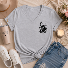 Load image into Gallery viewer, Gray v-neck graphic tee featuring a small black skeleton hand and āWife Lifeā design on the front chest.