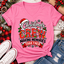Load image into Gallery viewer, Christmas Crew Making Memories Together graphic on a pink crewneck T-shirt, featuring red lettering, colorful Christmas lights, a Santa hat, holly, and snowflakes.
