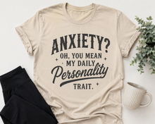 Load image into Gallery viewer, Beige graphic T-shirt with black vintage-style lettering reading Anxiety? Oh, You Mean My Daily Personality Trait.
