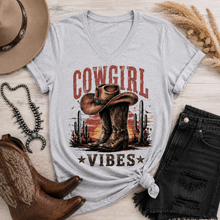 Load image into Gallery viewer, Cowgirl Vibes western graphic apparel featuring cowboy boots, cowgirl hat, cacti and desert sunset design
