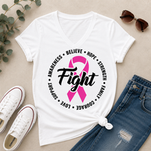Load image into Gallery viewer, White short-sleeve V-neck T-shirt laid flat with a pink ribbon and the word 'Fight' printed on the front, surrounded by black text reading 'Awareness • Believe • Hope • Strength • Family • Love • Courage'. Styled flat-lay with blue jeans, white sneakers, sunglasses, and eucalyptus leaves on a beige surface.
