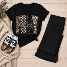 Load image into Gallery viewer, Black Just Pray V-neck graphic T-shirt with leopard, checkerboard, cow-print, star, and gold accents styled with black pocket leggings and sneakers.
