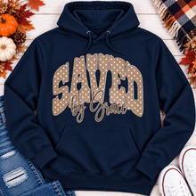Load image into Gallery viewer, Saved by Grace faith graphic apparel with polka dot lettering, available in brown, navy and black V-neck, long sleeve, crewneck and hoodie styles.
