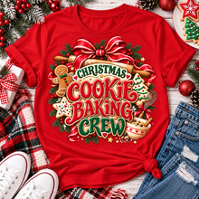 Load image into Gallery viewer, Christmas Cookie Baking Crew holiday graphic apparel featuring festive red and green lettering, gingerbread cookies, rolling pin, mixing bowl, Christmas greenery and red bow. Available in red, black and sand in four styles: crewneck tee, V-neck tee, sweatshirt and hoodie.
