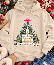 Load image into Gallery viewer, Oh Come Let Us Adore Him Christian Christmas graphic apparel with church, Christmas trees, stars and pink bow
