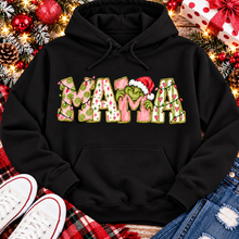 Load image into Gallery viewer, Christmas MAMA graphic shirt featuring pink and green patterned lettering, colorful holiday lights, and a Grinch-inspired character wearing a Santa hat.

