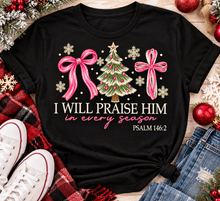 Load image into Gallery viewer, Christian Christmas shirt featuring I Will Praise Him in Every Season Psalm 146:2 graphic with pink bows, decorated Christmas tree, and cream snowflakes.
