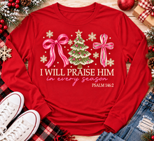 Load image into Gallery viewer, Christian Christmas shirt featuring I Will Praise Him in Every Season Psalm 146:2 graphic with pink bows, decorated Christmas tree, and cream snowflakes.
