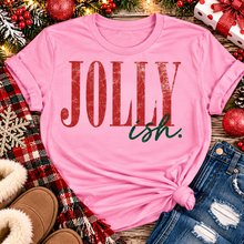 Load image into Gallery viewer, Jolly Ish Christmas graphic shirt featuring large distressed red JOLLY lettering with green handwritten ish script. Funny vintage-inspired holiday apparel available in pink and black, offered in short sleeve crewneck, V-neck, long sleeve and hoodie styles.
