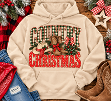 Load image into Gallery viewer, Country Christmas graphic tee with green plaid lettering, red polka dots, cowboy boots, western hat and festive Christmas bows.
