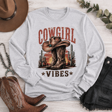 Load image into Gallery viewer, Cowgirl Vibes western graphic apparel featuring cowboy boots, cowgirl hat, cacti and desert sunset design
