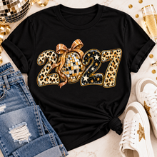 Load image into Gallery viewer, Black 2027 New Year's graphic apparel featuring leopard print numbers, a gold disco ball with an oversized glittery bow, black and gold stars, and sparkling accents. Available in crewneck tee, V-neck tee, sweatshirt, and hoodie styles.

