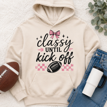 Load image into Gallery viewer, Cream Classy Until Kickoff football hoodie featuring a pink bow, black football, pink checkerboard pattern and black and pink game day lettering.
